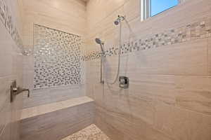 Full bathroom featuring a tile shower
