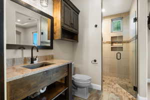 Bathroom featuring vanity, a stall shower, and recessed lighting