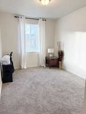 Spare room featuring carpet and baseboards