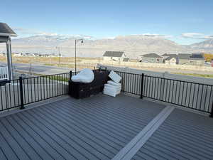 Wooden deck with a mountain view, a residential view, and area for grilling
