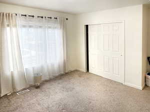 Unfurnished bedroom with carpet floors and a closet
