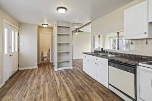Kitchen featuring white appliances, white cabinetry, dark wood-style floors, a ceiling fan, and open shelves
