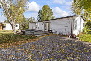 Rear view of property with a deck and a shed