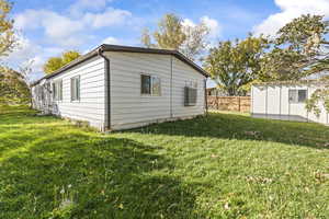 View of property exterior featuring an outdoor structure