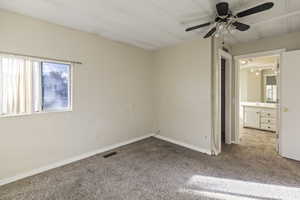 Unfurnished bedroom featuring carpet floors and ceiling fan