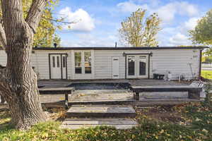 Back of property featuring a deck and french doors