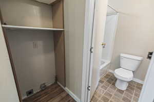 Full bath featuring toilet and shower / bath combination