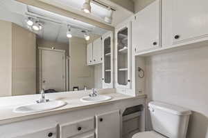 Bathroom featuring double vanity and toilet