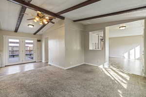 Empty room with a ceiling fan and carpet floors