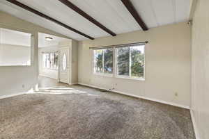 Carpeted empty room with healthy amount of natural light