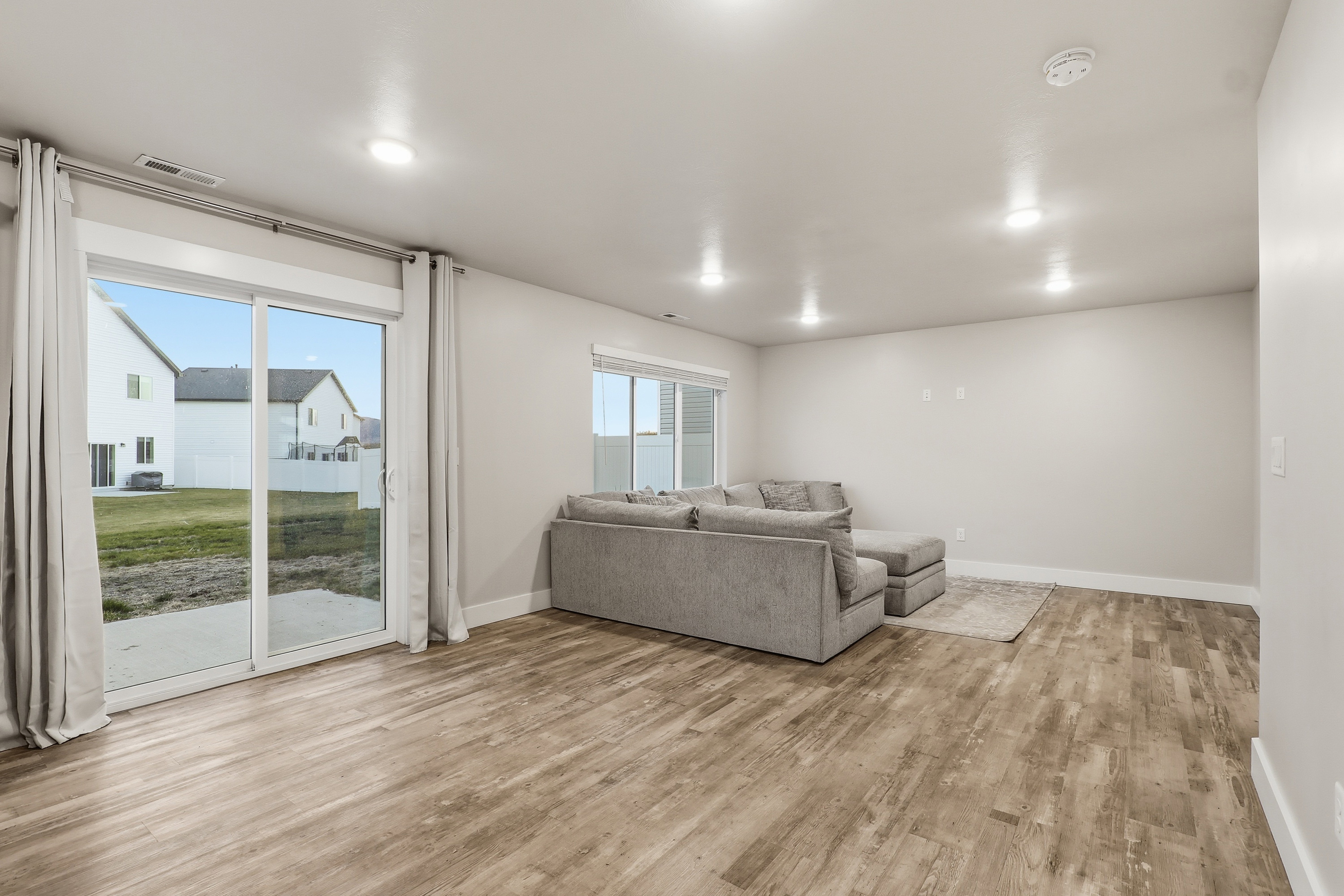 Living area featuring baseboards and light wood-style flooring