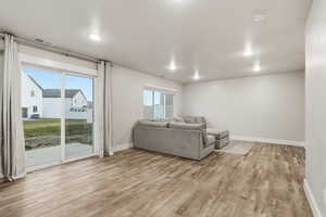 Living area featuring baseboards and light wood-style flooring