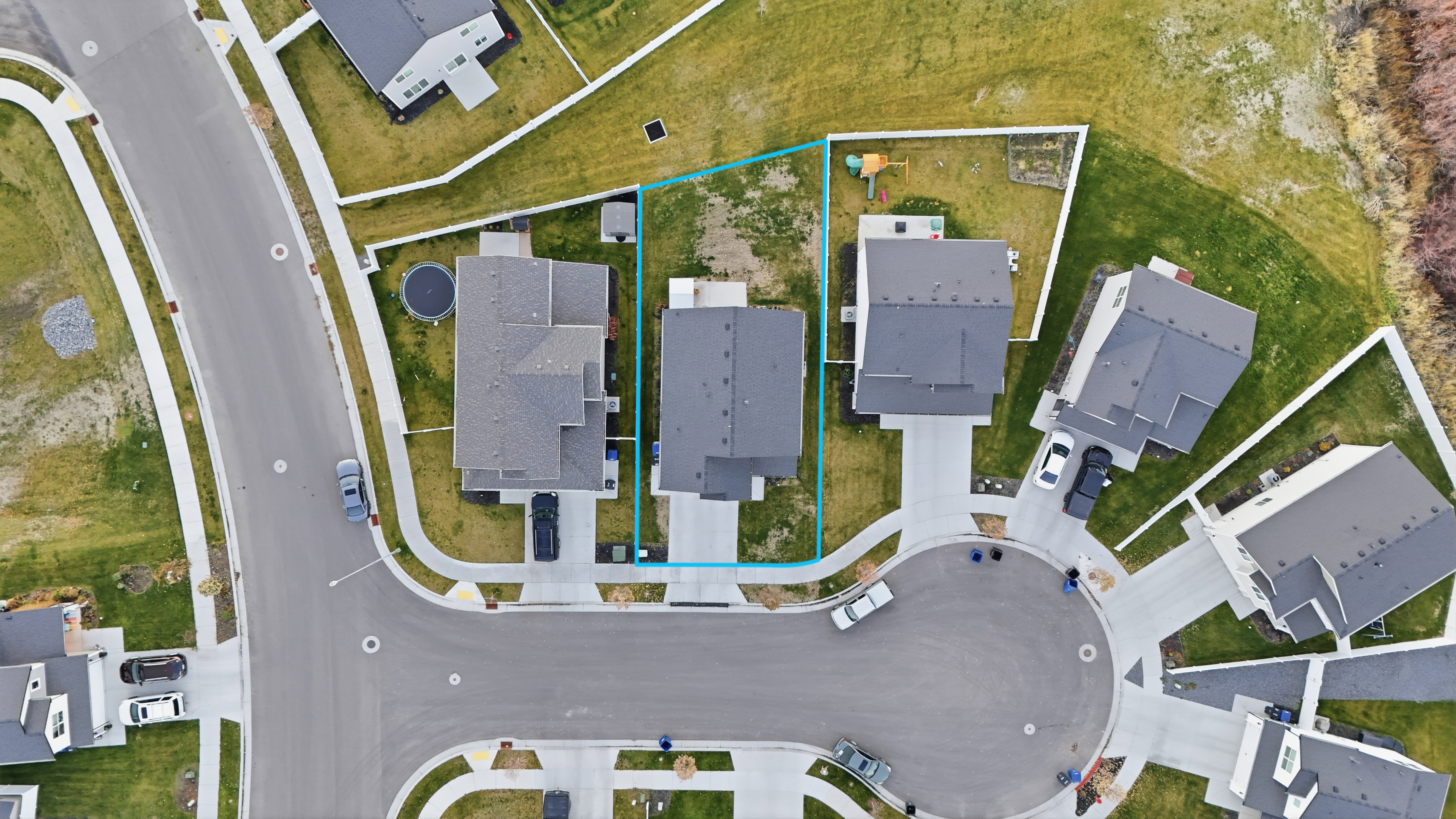 Aerial view of residential area with property boundaries highlighted