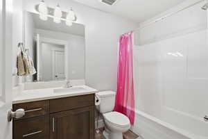 Bathroom featuring vanity and shower / bath combo