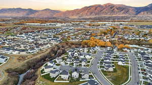 Aerial view of property's location with nearby suburban area and Wellsville mountains in the background