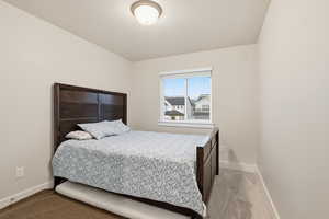 Bedroom featuring light colored carpet and baseboards