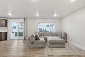 Living room with light wood-style floors and baseboards