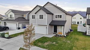 View of front of property featuring concrete driveway, a shingled roof, a residential view, board and batten siding, and a garage