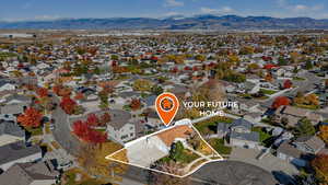 Aerial perspective of suburban area featuring a mountain backdrop