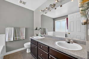 Master Bathroom with double vanity and toilet