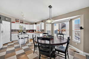 Dining room featuring vaulted ceiling and light flooring