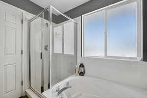 Master Bathroom featuring a shower stall and a bath