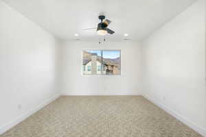Spare room featuring ceiling fan, light carpet, and recessed lighting