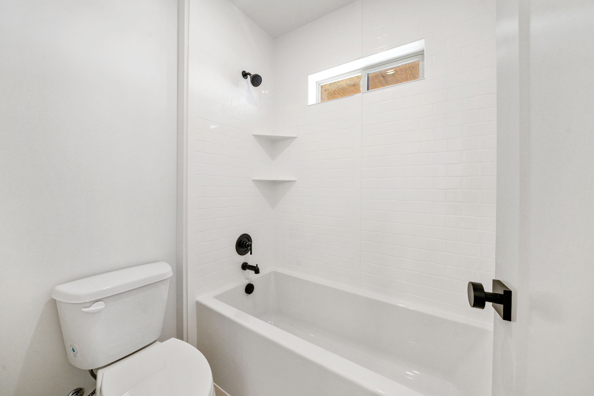 Bathroom featuring shower / bath combination and toilet