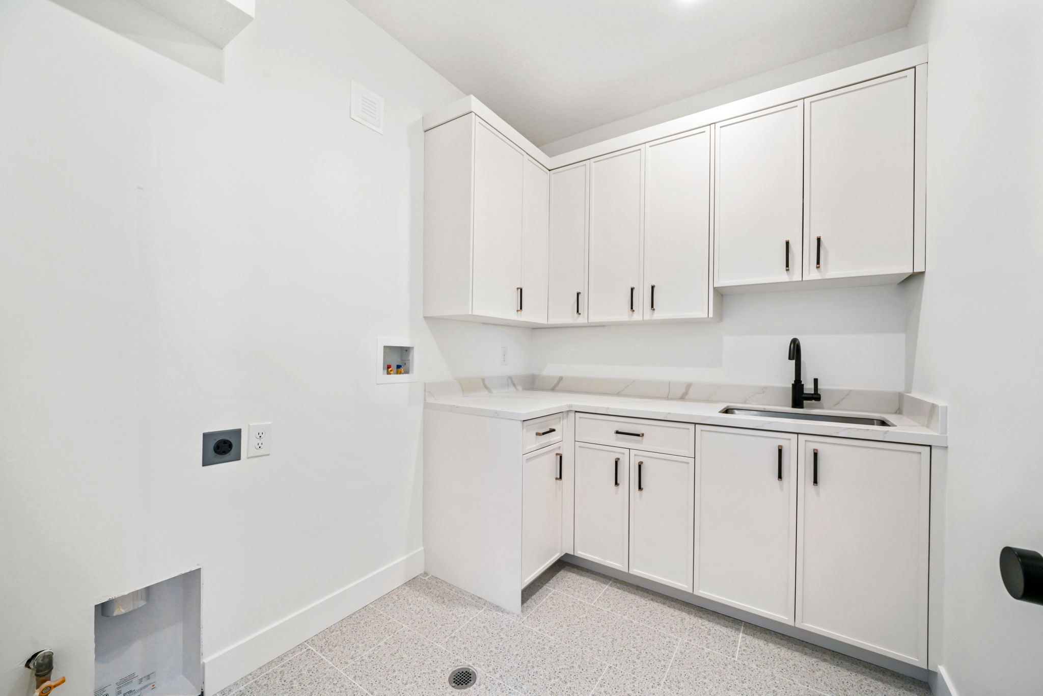 Laundry room with hookup for a washing machine, cabinet space, and hookup for an electric dryer