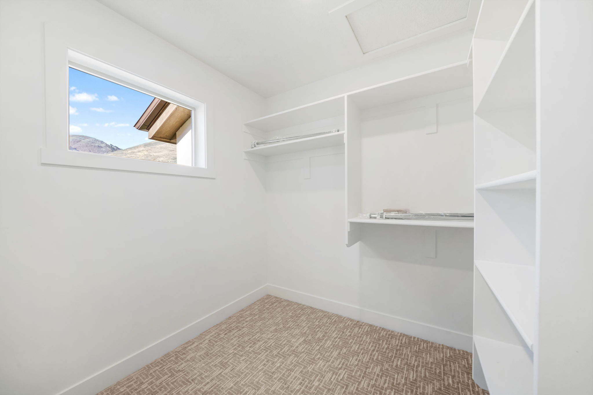 Walk in closet featuring attic access