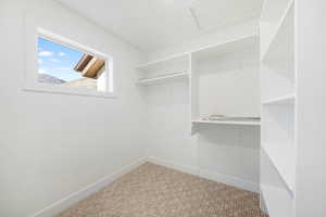 Walk in closet featuring attic access