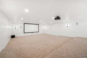 Cinema room featuring light colored carpet and recessed lighting