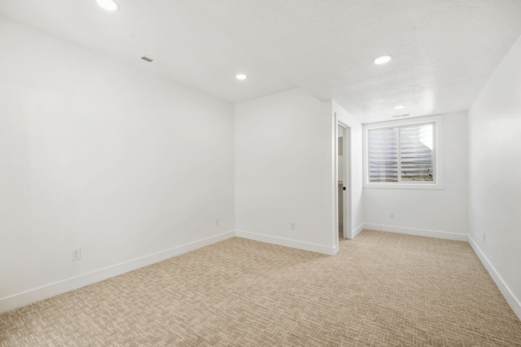 Spare room with recessed lighting and light colored carpet