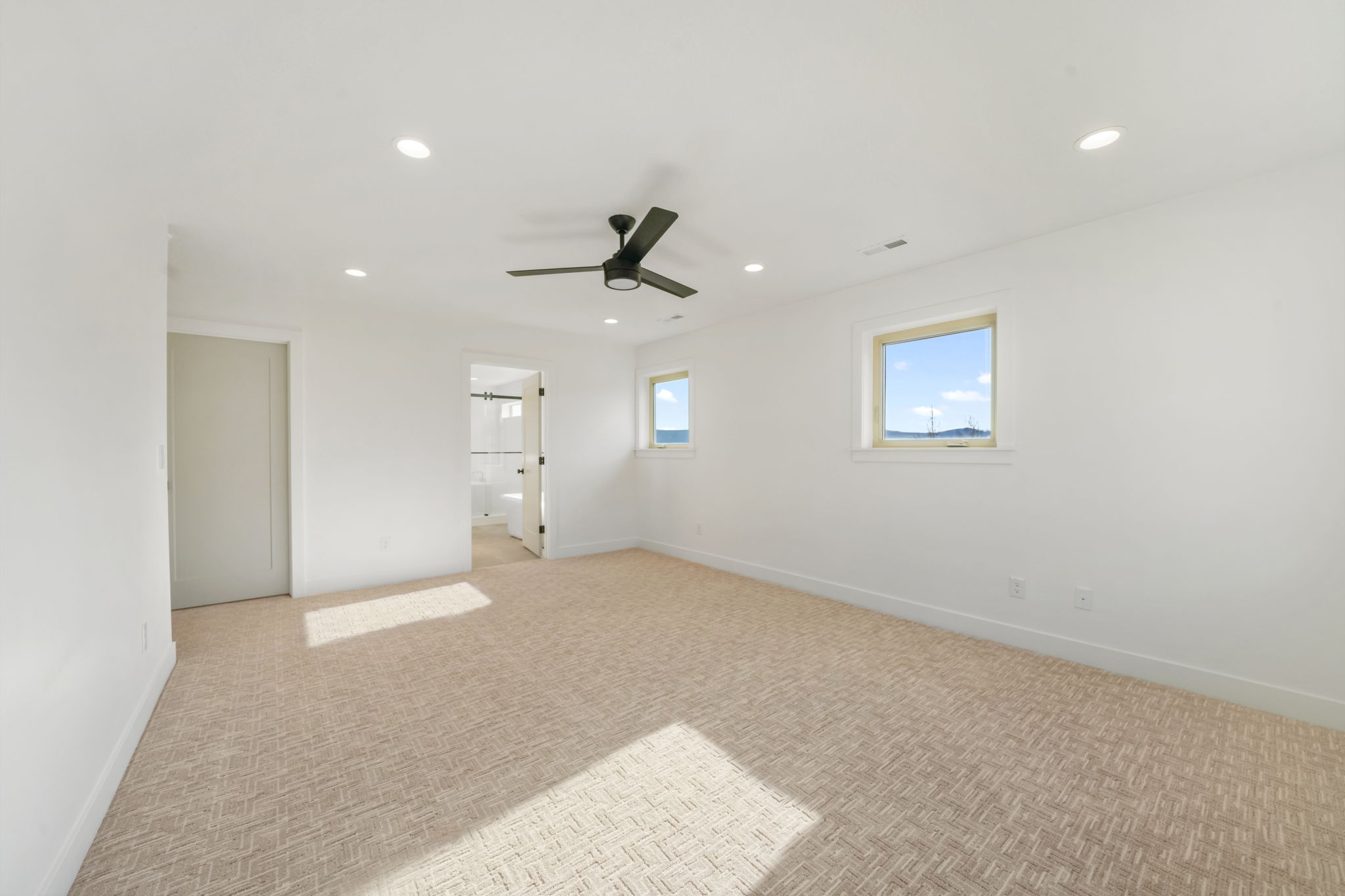 Unfurnished bedroom with recessed lighting, a ceiling fan, carpet flooring, and ensuite bath