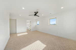 Unfurnished bedroom with recessed lighting, a ceiling fan, carpet flooring, and ensuite bath