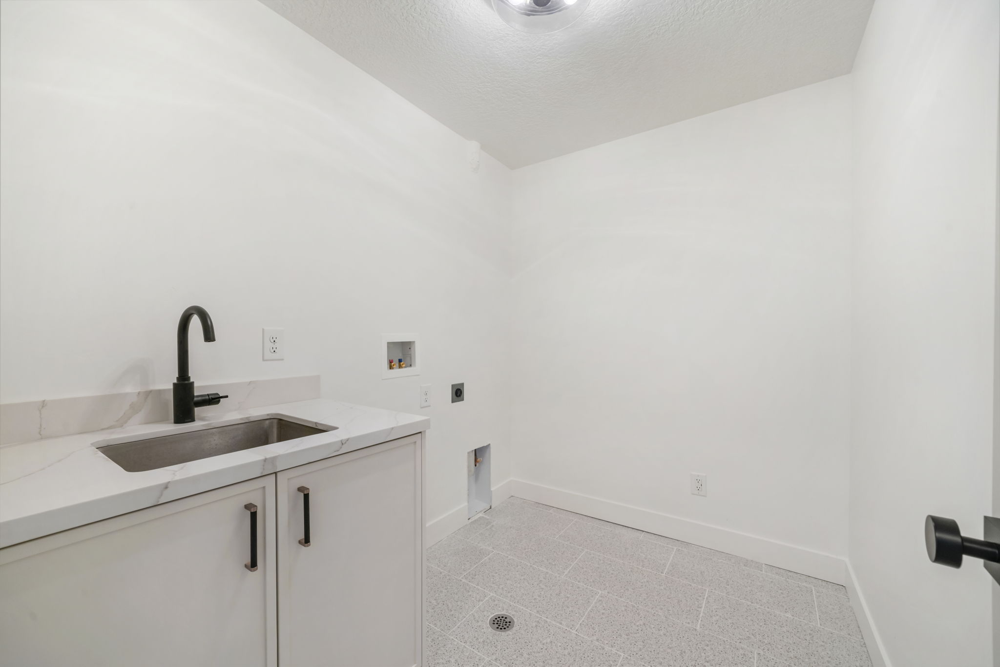 Laundry area featuring washer hookup, a textured ceiling, cabinet space, and electric dryer hookup