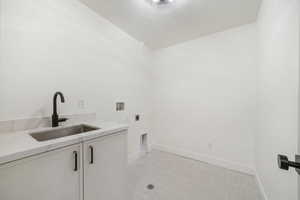 Laundry area featuring washer hookup, a textured ceiling, cabinet space, and electric dryer hookup