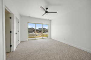 Spare room with a textured ceiling, light colored carpet, and a ceiling fan