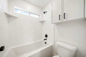 Full bath featuring shower / bath combination and toilet