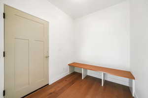 Mudroom with wood finished floors and baseboards