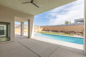 View of swimming pool featuring a fenced backyard, a patio, and ceiling fan