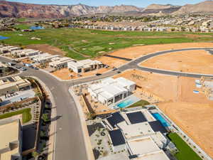 Aerial view of residential area with a golf course and a water and mountain view