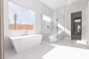 Bathroom featuring light marble finish flooring, a soaking tub, recessed lighting, and a marble finish shower
