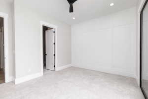 Unfurnished bedroom featuring light carpet, recessed lighting, a closet, and a ceiling fan