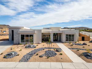 Contemporary home featuring stucco siding, a mountain view, and stone siding