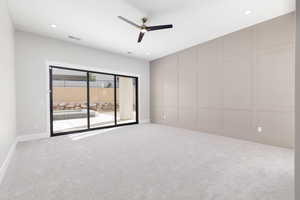Unfurnished room featuring a decorative wall, ceiling fan, recessed lighting, and light carpet