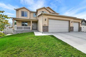 Traditional-style home with a gate, covered porch, concrete driveway, and stucco siding