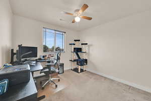 Office space with light carpet and ceiling fan