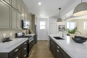 A total 'wow' kitchen-quartz countertops, stainless appliances, and a big island for charcuterie or homework.*Model Home
