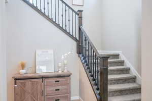 Staircase featuring baseboards
